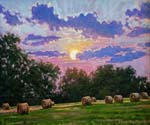 Sunset over hayrolls